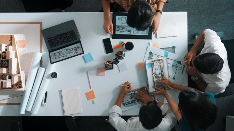“Team collaborating on digital marketing strategy with charts and laptop”